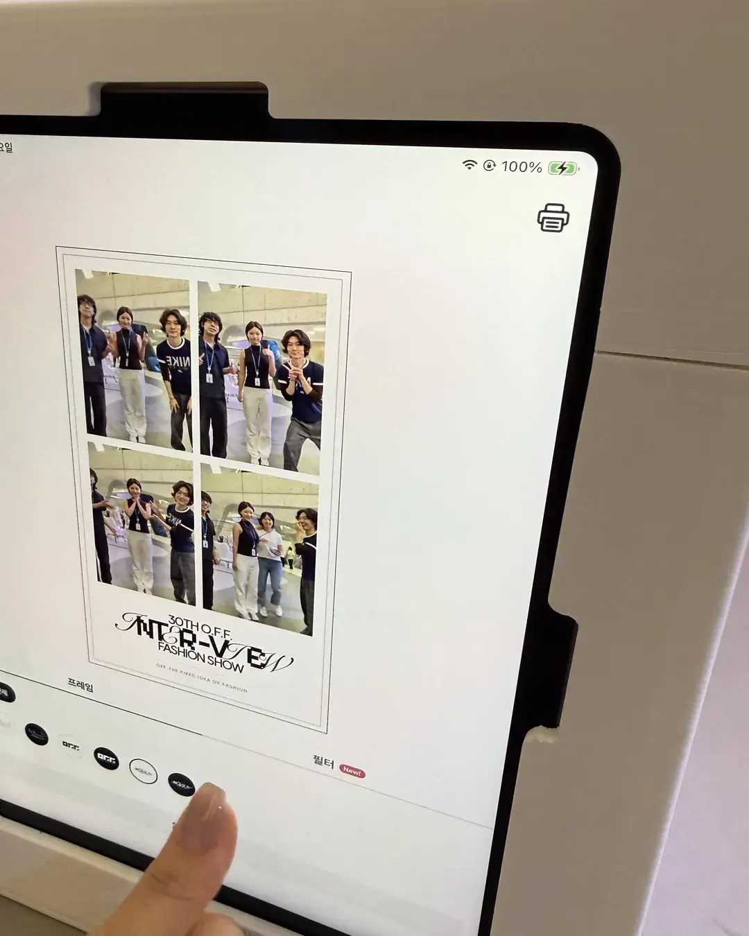 An iPad screen showing a four-photo strip preview with the INTER-VIEW fashion show text at the bottom of the event frame
