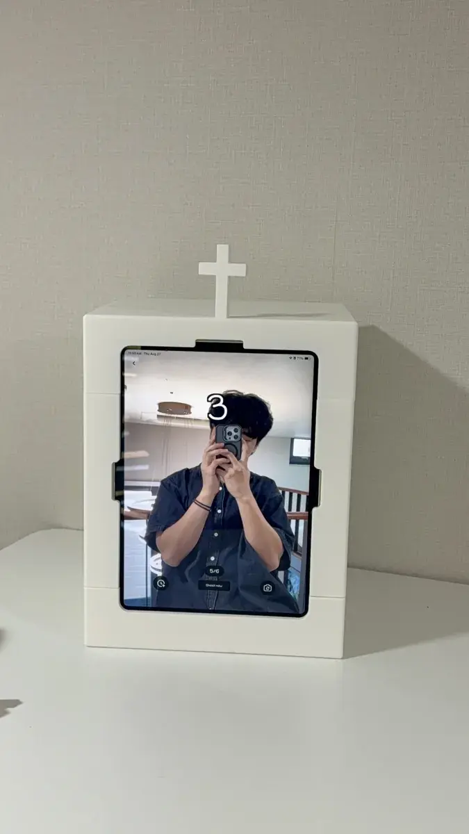 A youth group member taking photos at the mini booth in a church lobby