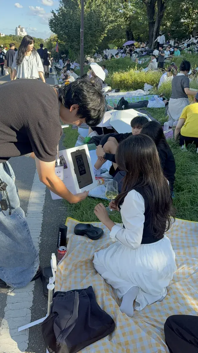 The my4cut team helping a group shoot with the mini booth at Hangang Park in the evening