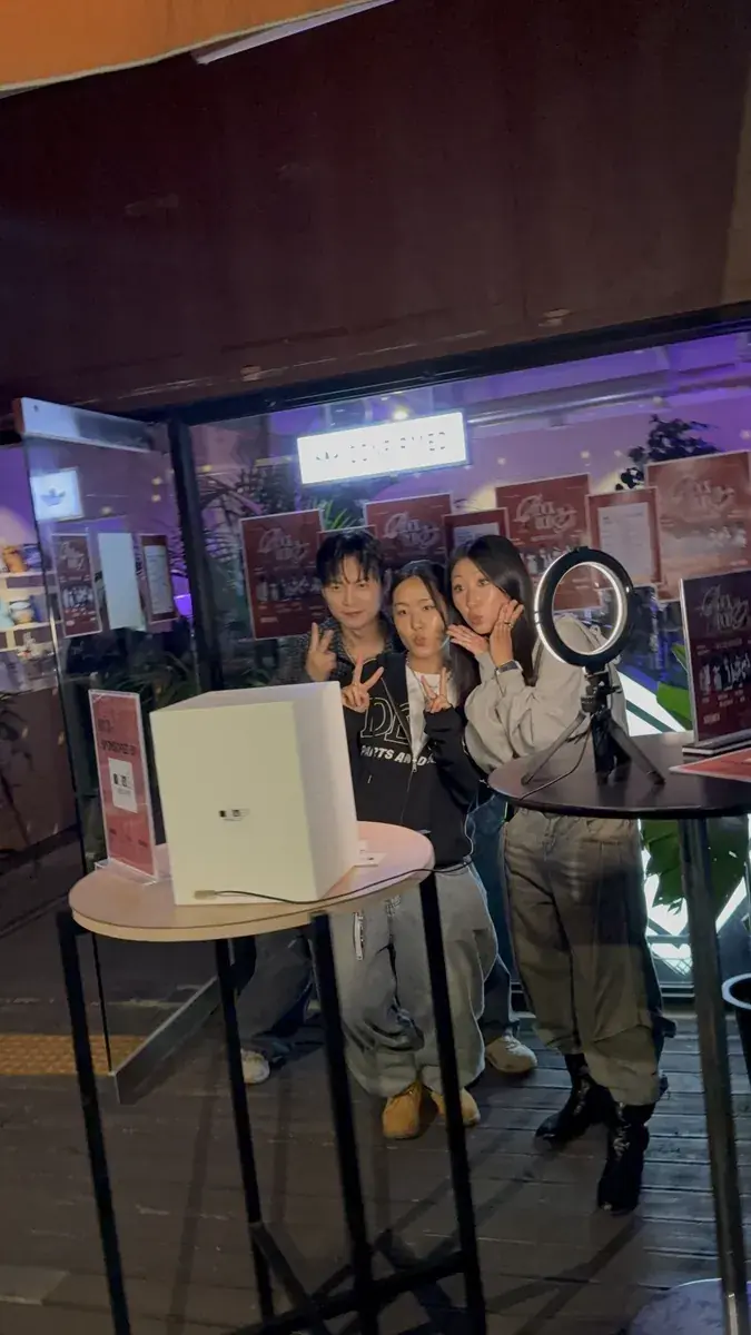 A my4cut mini booth glowing at a rooftop party at night