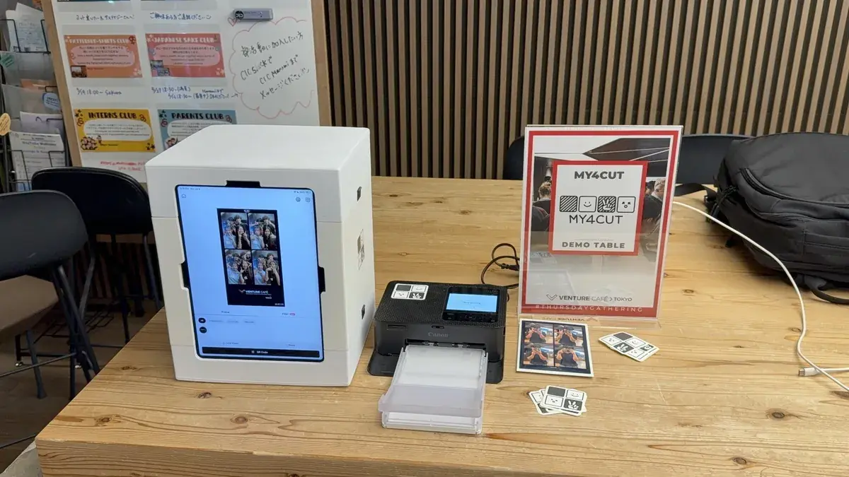 A my4cut mini booth and a photo printer side by side on a demo table