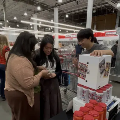 Shoppers taking photos with a white my4cut mini booth next to a pop-up store display